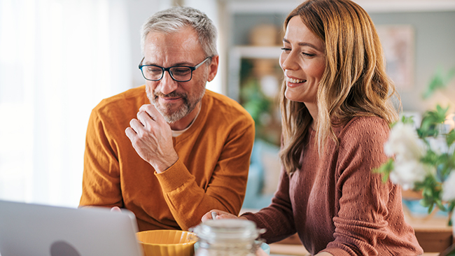couple budgeting on laptop