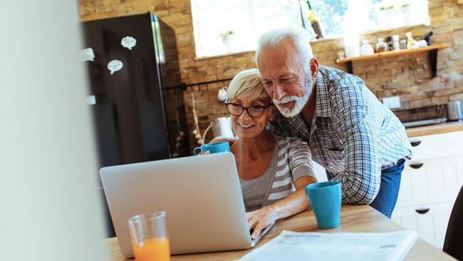 happy couple at computer