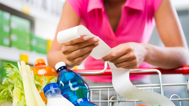 woman reading a shopping receipt