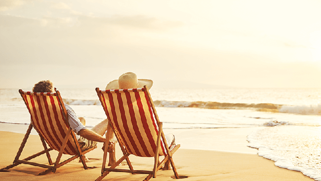 Couple on deckchairs looking out to sea