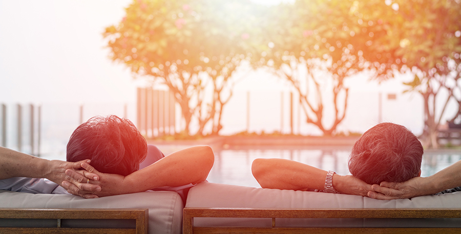 couple relaxing by pool